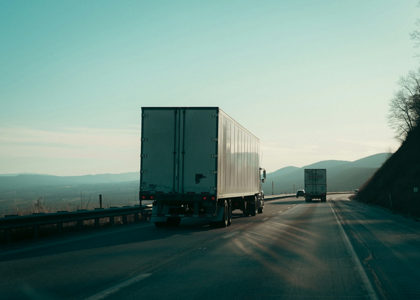 A freight truck on the highway at dusk